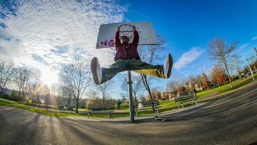 Basketball player measuring jump reach to calculate dunk height